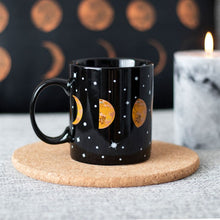 Load image into Gallery viewer, Celestial Magic: Black Ceramic Mug with Moon Phases Design
